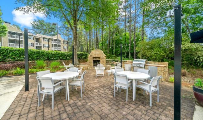 a patio with tables and chairs