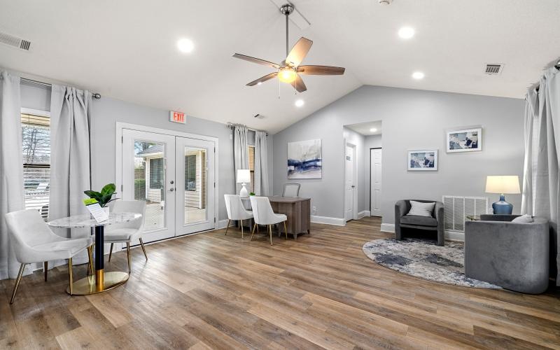 a room with a wood floor and a table and chairs