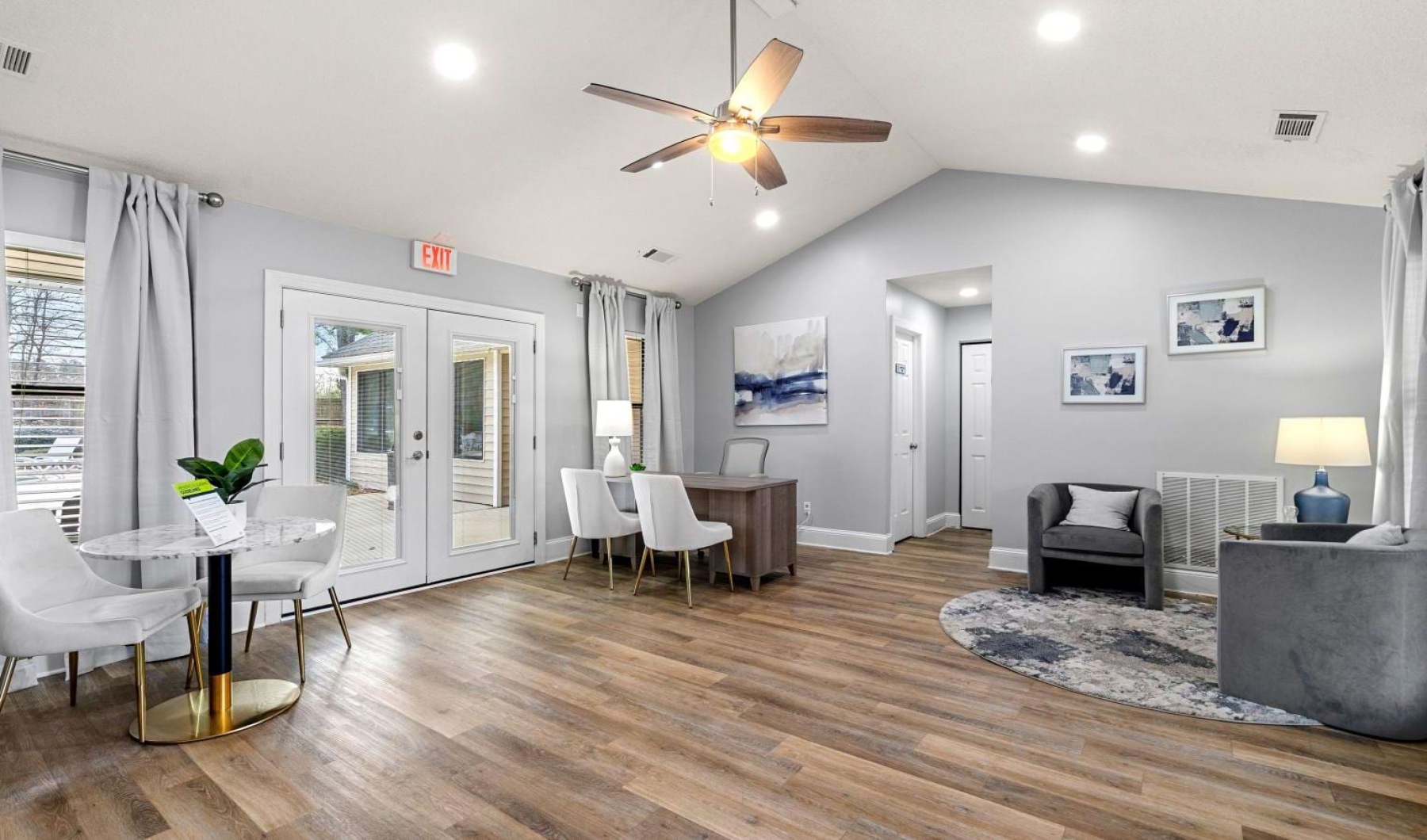 a room with a wood floor and a table and chairs